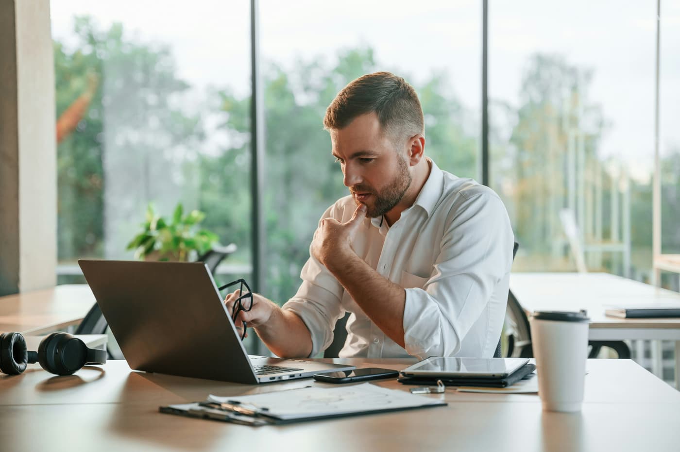 Professional reviewing work on a laptop